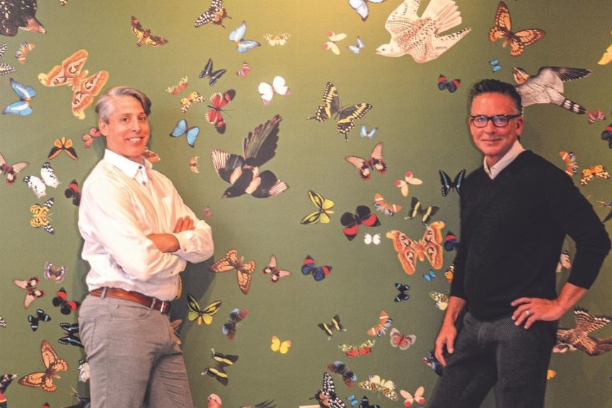 men standing by butterfly wall